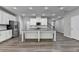 Modern kitchen with a large island, stainless steel appliances, and vinyl plank flooring at 315 Duval Dr, Alpharetta, GA 30009