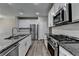 Modern kitchen featuring stainless steel appliances, white cabinets, and granite countertops at 315 Duval Dr, Alpharetta, GA 30009