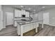 Modern kitchen with white cabinets, stainless steel appliances, granite countertops, and hardwood flooring at 315 Duval Dr, Alpharetta, GA 30009
