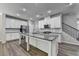 Modern kitchen with granite countertops, stainless steel appliances, white cabinets, and hardwood floors at 315 Duval Dr, Alpharetta, GA 30009
