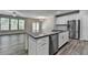 Open living space with fireplace, large windows, hardwood floors, and access to the patio at 315 Duval Dr, Alpharetta, GA 30009