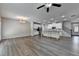 Open-concept living room with vinyl floors, recessed lighting, and a modern kitchen and staircase at 315 Duval Dr, Alpharetta, GA 30009