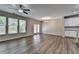 Bright living room with large windows, hardwood floors, and white kitchen with island in the background at 315 Duval Dr, Alpharetta, GA 30009