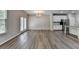 Bright living space features vinyl plank flooring, recessed lighting, and a view to the modern kitchen at 315 Duval Dr, Alpharetta, GA 30009
