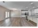Open-concept living space with luxury vinyl plank flooring and a modern kitchen with stainless steel appliances at 315 Duval Dr, Alpharetta, GA 30009