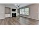 Bright and airy living room featuring a fireplace with built-in cabinets and large windows at 315 Duval Dr, Alpharetta, GA 30009