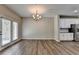 Open-concept living room with vinyl floors, adjacent to the modern kitchen with stainless appliances at 315 Duval Dr, Alpharetta, GA 30009