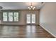 Living room area with patio access and adjacent kitchen with stainless appliances at 315 Duval Dr, Alpharetta, GA 30009