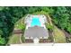 Aerial view of a secluded community pool area, set among mature trees, with a clubhouse and comfortable seating at 315 Duval Dr, Alpharetta, GA 30009