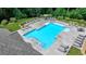Aerial view of a community pool surrounded by lounge chairs and lush landscaping for relaxation at 315 Duval Dr, Alpharetta, GA 30009