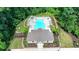 Aerial shot of a community pool and clubhouse nestled among lush trees and well-maintained landscaping at 315 Duval Dr, Alpharetta, GA 30009