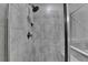 Close up of walk-in shower with tile surround and chrome shower head at 315 Duval Dr, Alpharetta, GA 30009