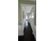 Hallway with dark wood floors, white trim, and plenty of natural light from nearby windows at 3750 Richmond Bnd, Lithonia, GA 30038