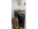 Convenient laundry room with modern washer and dryer, plus a shelf for storing supplies at 3750 Richmond Bnd, Lithonia, GA 30038
