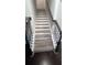 Stairway with hardwood treads, wrought iron railing, and a freshly painted white finish at 3750 Richmond Bnd, Lithonia, GA 30038