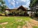Expansive backyard with a covered patio, featuring outdoor kitchen, dining, and seating areas for entertaining at 134 Carolinas Way, Fayetteville, GA 30215