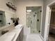 Bright bathroom featuring double sink vanity, modern shower with glass, and updated fixtures at 134 Carolinas Way, Fayetteville, GA 30215