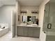 Bright bathroom featuring double sink vanity, modern shower, and a luxurious soaking tub at 134 Carolinas Way, Fayetteville, GA 30215
