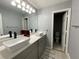 Bright bathroom featuring double sinks, modern fixtures, and a separate toilet area for added convenience at 134 Carolinas Way, Fayetteville, GA 30215