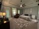 Spacious main bedroom with trey ceiling, neutral walls, an exterior door, and updated ceiling fan at 134 Carolinas Way, Fayetteville, GA 30215