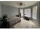 Cozy bedroom with ample natural light, neutral walls, and ceiling fan, perfect for relaxation and rest at 134 Carolinas Way, Fayetteville, GA 30215