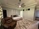 Comfortable primary bedroom showcasing a ceiling fan, trey ceiling, and cozy seating area at 134 Carolinas Way, Fayetteville, GA 30215