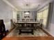 Bright dining room with a large table, stylish light fixture, and elegant decor for memorable gatherings at 134 Carolinas Way, Fayetteville, GA 30215