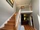 Grand foyer showcasing a hardwood staircase, neutral walls, and views into the living area at 134 Carolinas Way, Fayetteville, GA 30215