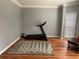 Bright exercise room with wood floors, a treadmill, and natural light at 134 Carolinas Way, Fayetteville, GA 30215