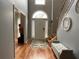 Inviting foyer with hardwood floors, high ceilings, and a staircase with wooden banister at 134 Carolinas Way, Fayetteville, GA 30215