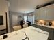 Bright eat-in kitchen featuring granite countertops, stylish cabinets and modern lighting at 134 Carolinas Way, Fayetteville, GA 30215