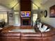 Open concept living area featuring vaulted ceilings, fireplace, and leather seating at 134 Carolinas Way, Fayetteville, GA 30215