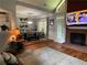 Open concept living area with hardwood floors, fireplace, and abundant natural light at 134 Carolinas Way, Fayetteville, GA 30215