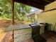 Outdoor covered porch featuring a built-in kitchen, ideal for grilling, cooking, and outdoor entertaining at 134 Carolinas Way, Fayetteville, GA 30215