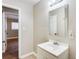 Bright bathroom with a single sink vanity, mirror and an adjoining bedroom entrance at 2600 Nw Baker Rd, Atlanta, GA 30318