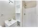 Modern bathroom with a white vanity, tiled floors, and shower with built-in shelves at 2600 Nw Baker Rd, Atlanta, GA 30318