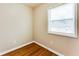 A small bedroom with a window for natural light and hardwood floors at 2600 Nw Baker Rd, Atlanta, GA 30318