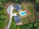 Aerial view of the backyard featuring a kidney bean-shaped pool, trampoline, and well-manicured lawn at 3640 Pollys Blf, Cumming, GA 30028