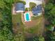 Aerial view highlighting the kidney-shaped pool, spacious lawn, and the surrounding trees at 3640 Pollys Blf, Cumming, GA 30028