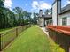 Expansive backyard with a hot tub, patio, and black fencing, offering a private and serene outdoor experience at 3640 Pollys Blf, Cumming, GA 30028