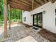 View of backyard with black framed french doors, gravel and stone ground cover and white exterior walls at 3640 Pollys Blf, Cumming, GA 30028