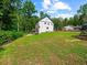 Large backyard view with a home, wooden deck, trampoline and wooden fence at 3640 Pollys Blf, Cumming, GA 30028