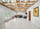 Partially finished basement with exposed ceiling, featuring a seating area, and exterior access at 3640 Pollys Blf, Cumming, GA 30028