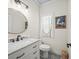 Stylish powder room featuring a modern vanity with marble countertop and decorative floor tiles at 3640 Pollys Blf, Cumming, GA 30028