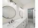 Bright bathroom with double vanity sinks, modern fixtures, and a connecting door to the bath and toilet area at 3640 Pollys Blf, Cumming, GA 30028