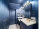 Elegant blue bathroom with granite countertop, modern fixtures, and ample vanity space, creating a luxurious feel at 3640 Pollys Blf, Cumming, GA 30028
