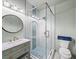 Elegant bathroom featuring a glass enclosed shower, a designer vanity, and modern lighting at 3640 Pollys Blf, Cumming, GA 30028