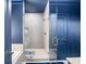 Stylish bathroom features a glass-enclosed shower with decorative tile and blue accents, creating a spa-like retreat at 3640 Pollys Blf, Cumming, GA 30028