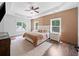 Spacious bedroom with tray ceiling, ceiling fan, hardwood floor and many windows at 3640 Pollys Blf, Cumming, GA 30028