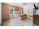 Bright bedroom boasts wood floors, tray ceiling, modern furniture and a large decorative rug at 3640 Pollys Blf, Cumming, GA 30028